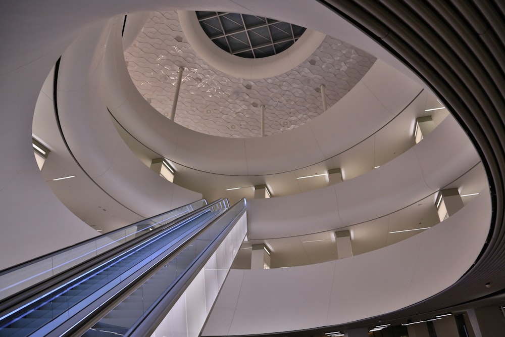 low-angle photography of escalator to the top floor