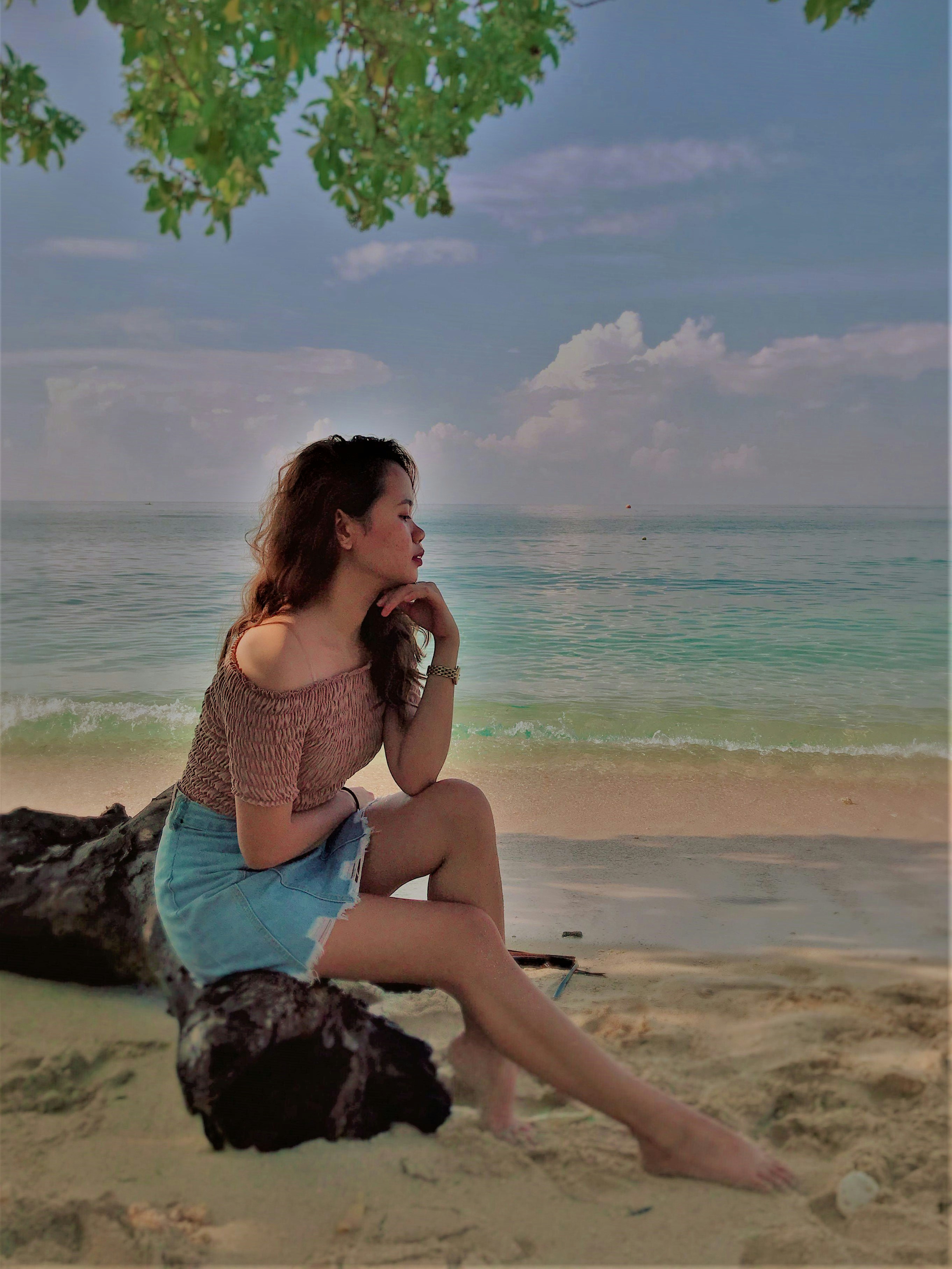 woman sitting on black rock
