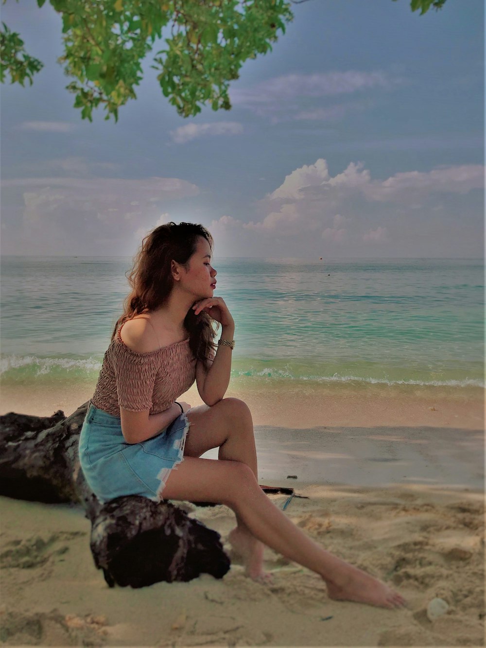 woman sitting on black rock