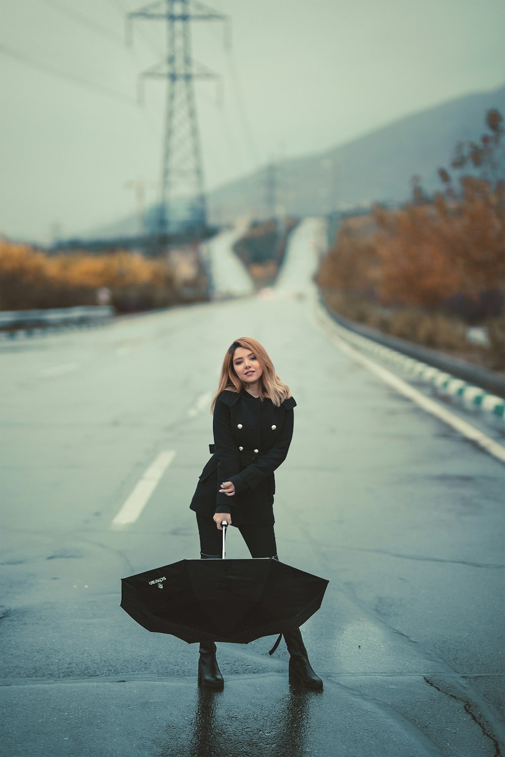 woman holding black umbrella