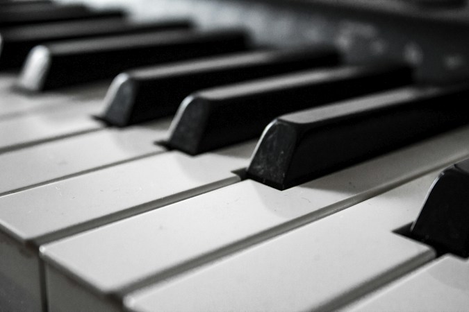 Black and white photo of an older piano, the kind of long-lived family instrument that needs regular tuning in the dry Las Vegas climate
