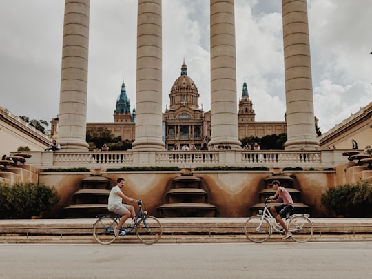 man riding bike during daytime in The Magic Fountain Spain