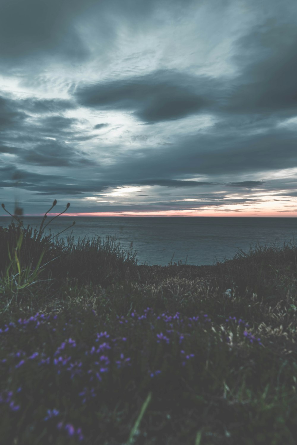 orange and grey sky over sea at dusk