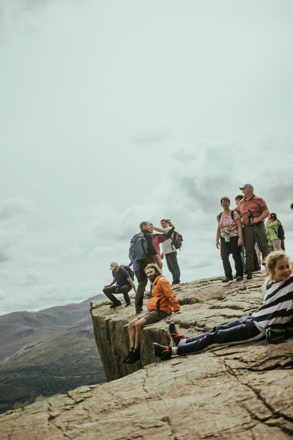 group of people standing on creek