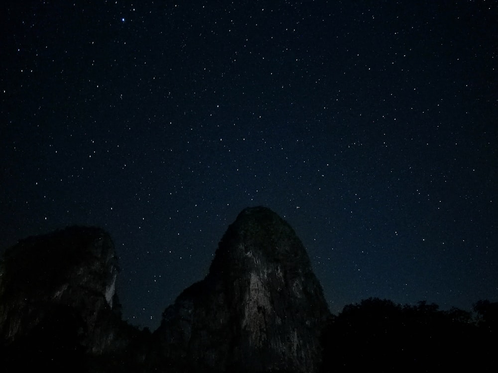 black mountain and a starry sky at night