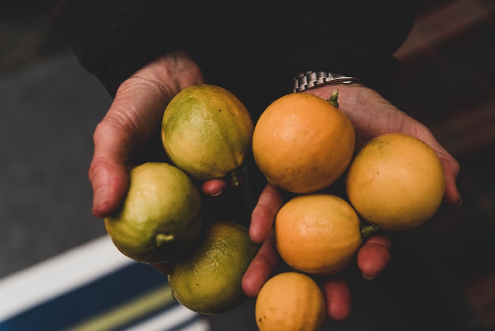 person holding yellow fruits close-up photography