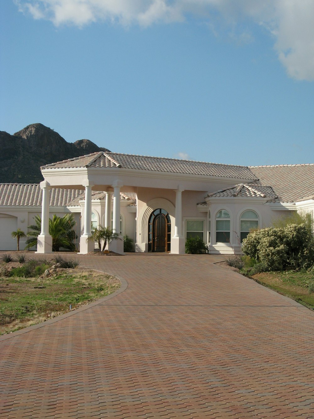 white painted house near mountain