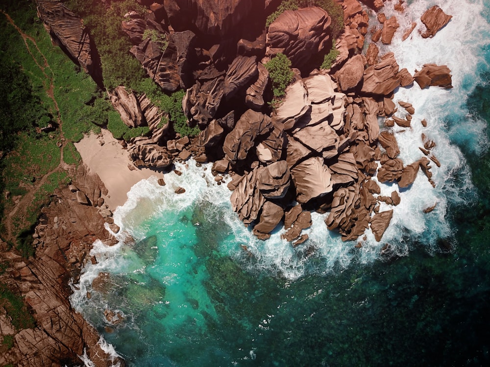 aerial photography of brown mountain near body of water