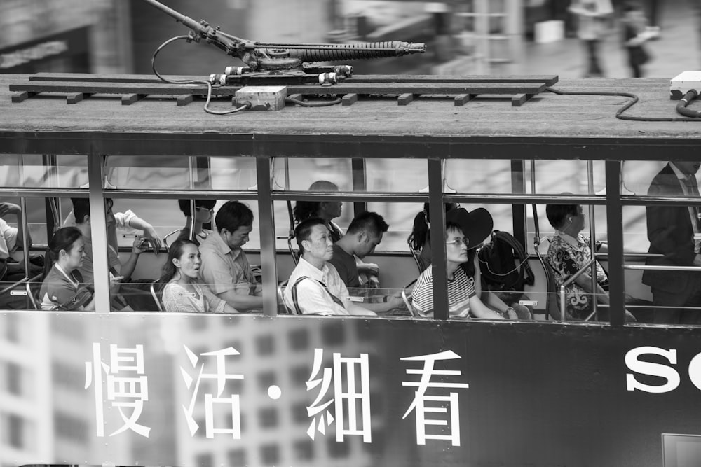 grayscale photo of people in a train cabin