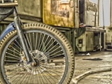A close-up of a bicycle wheel with tools nearby.