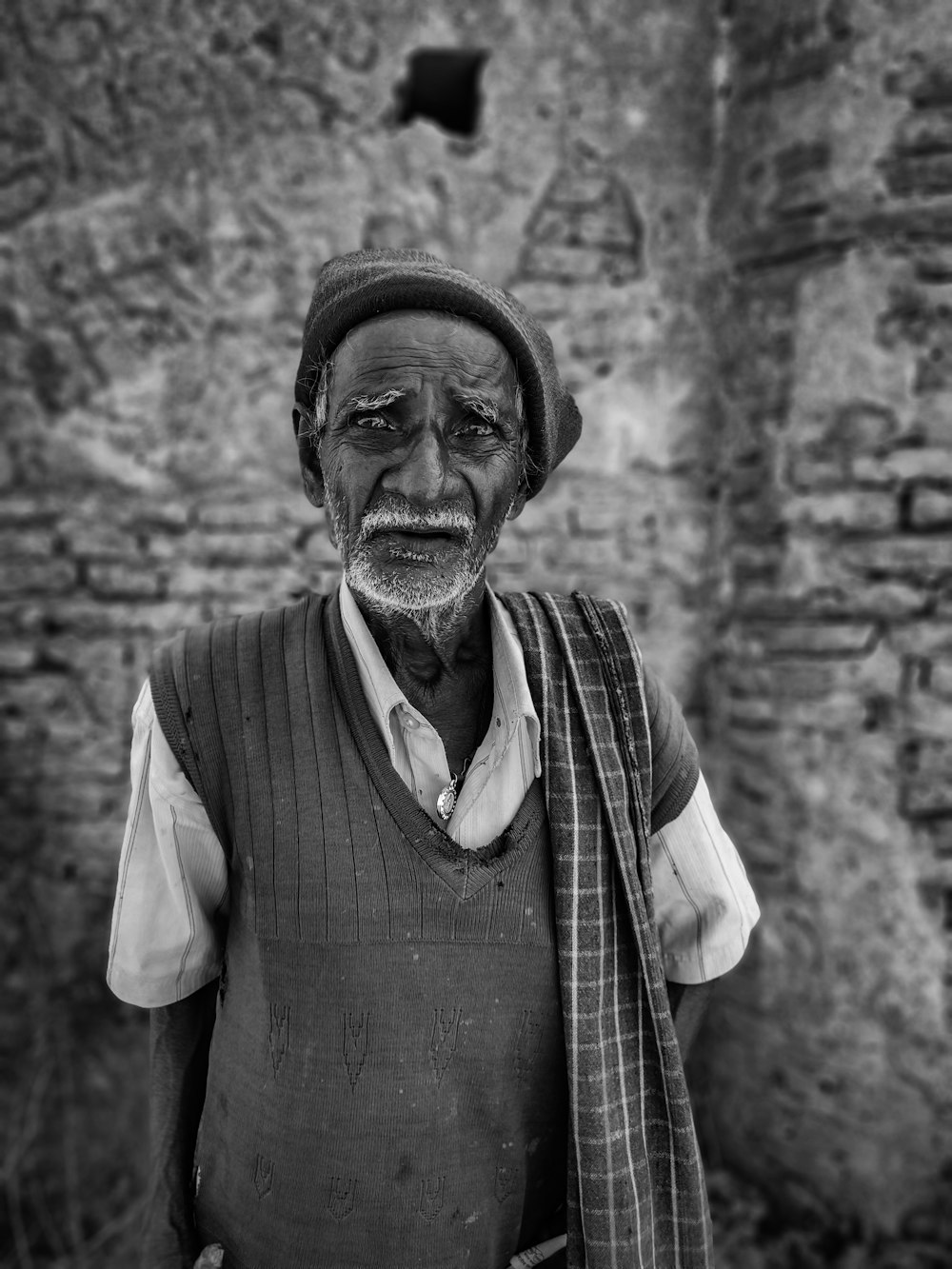 gray scale photo of man wearing scarf