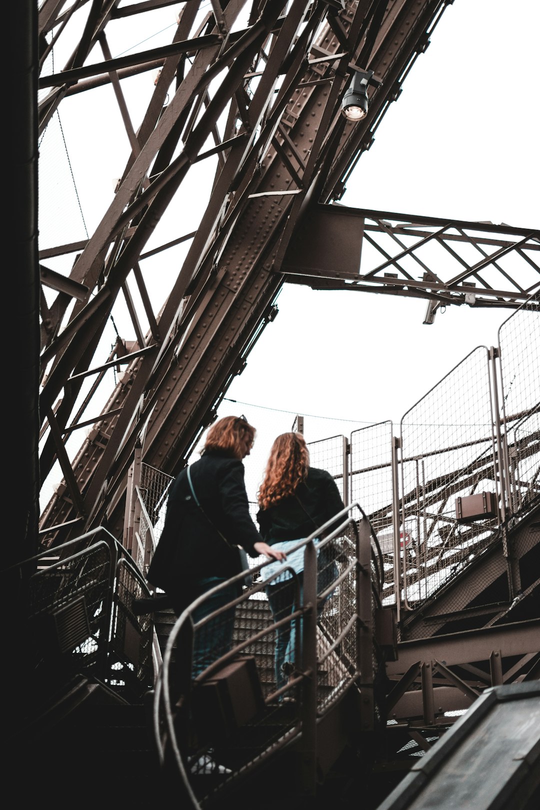 two person walking up on stair steps during daytime