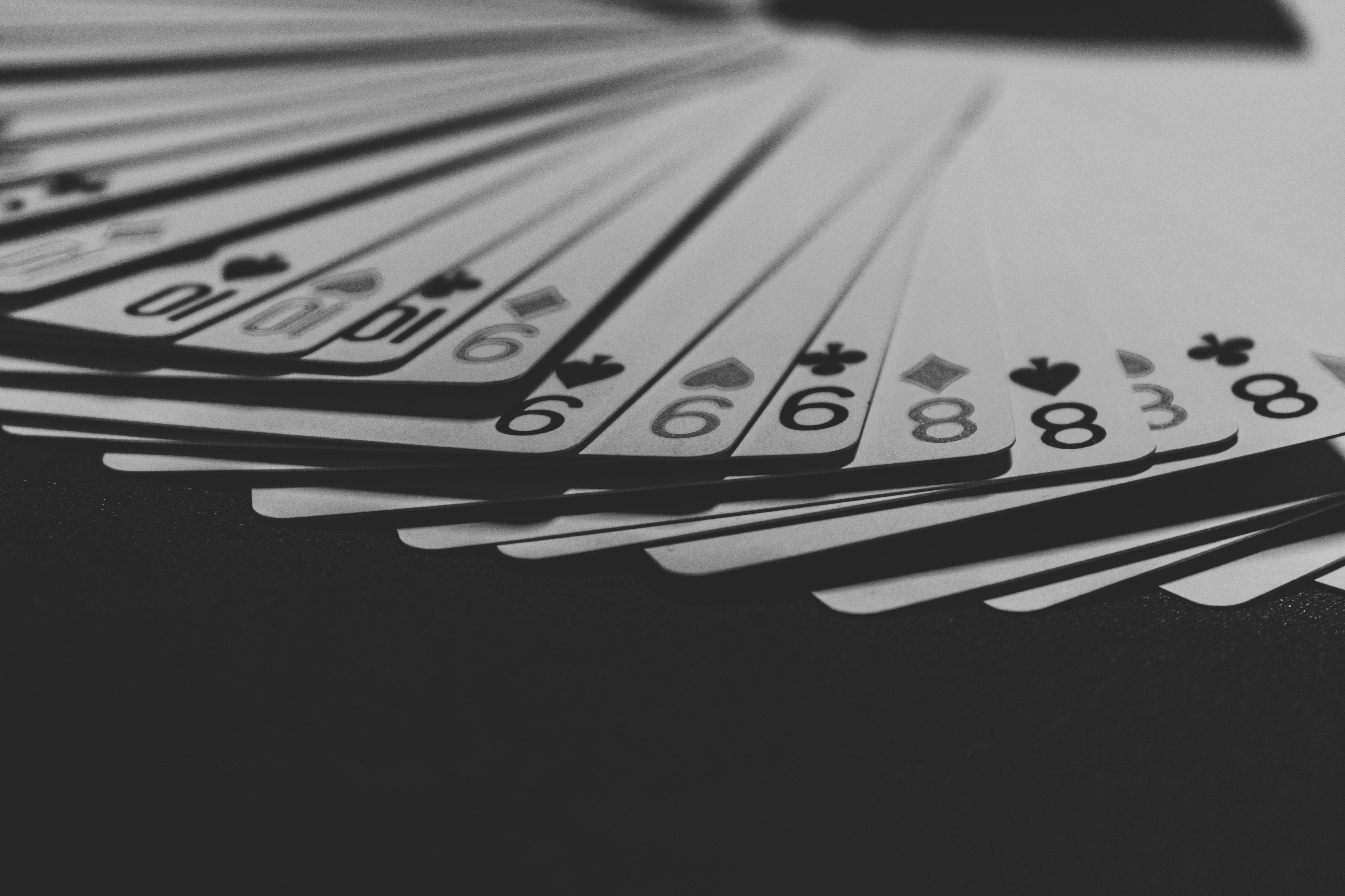grayscale photo of a fanned playing card