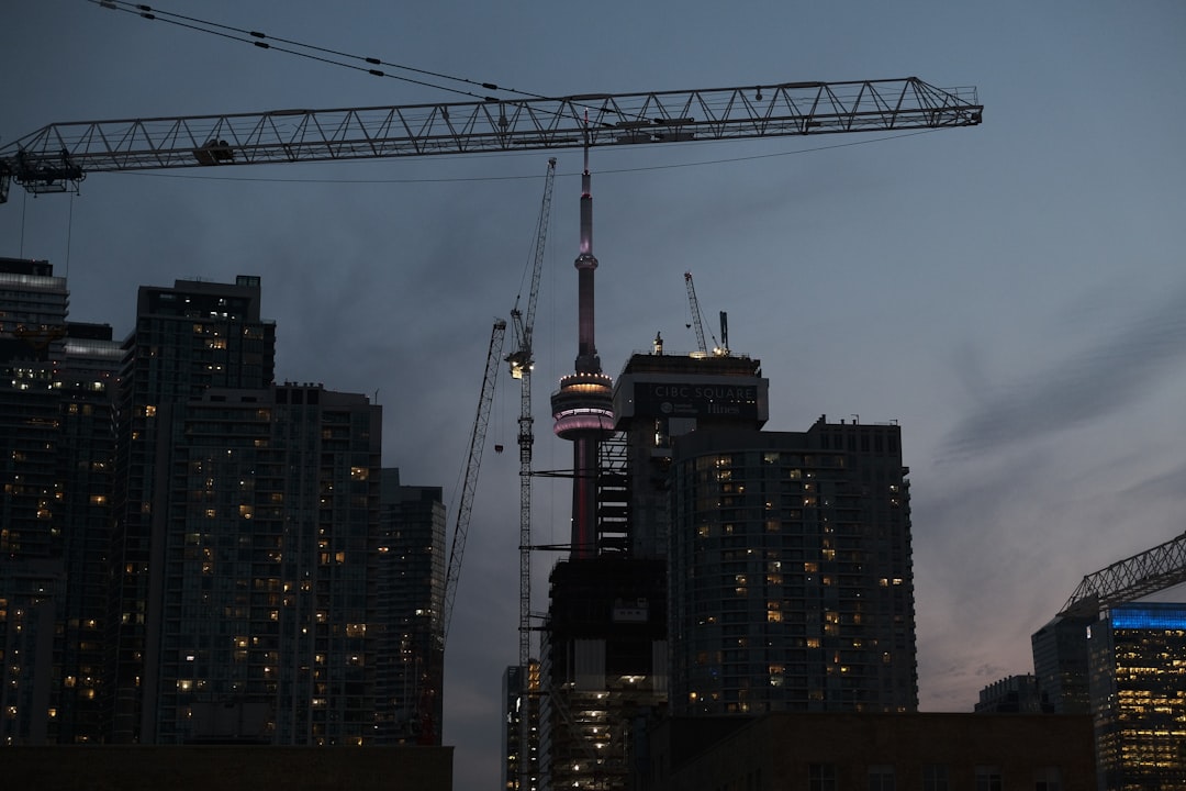 high-rise buildings with crane during nighttime