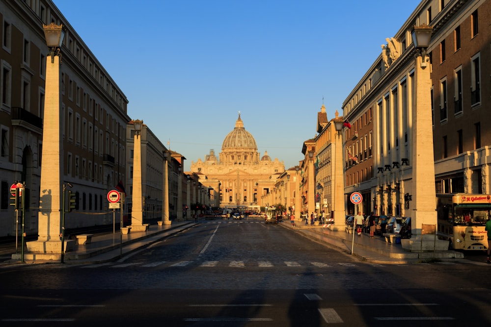 empty road in front of a building during golden hour