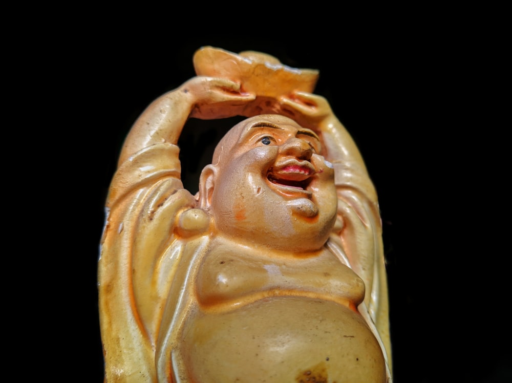 brown Buddha figurine close-up photography