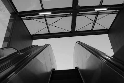 grayscale photo of empty banks of stairs