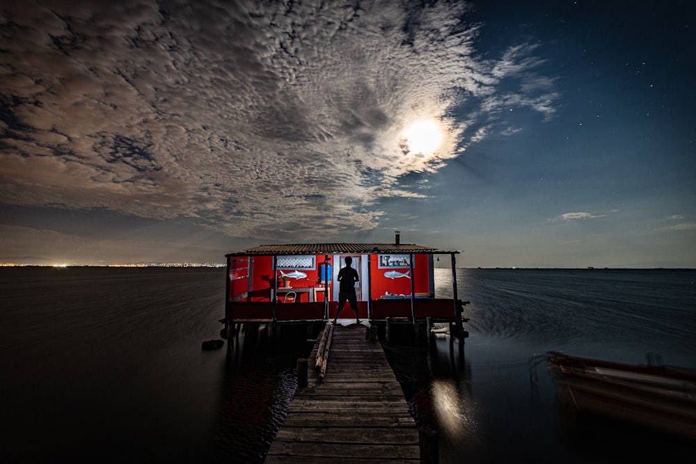 silhouette photo of man riding on boat