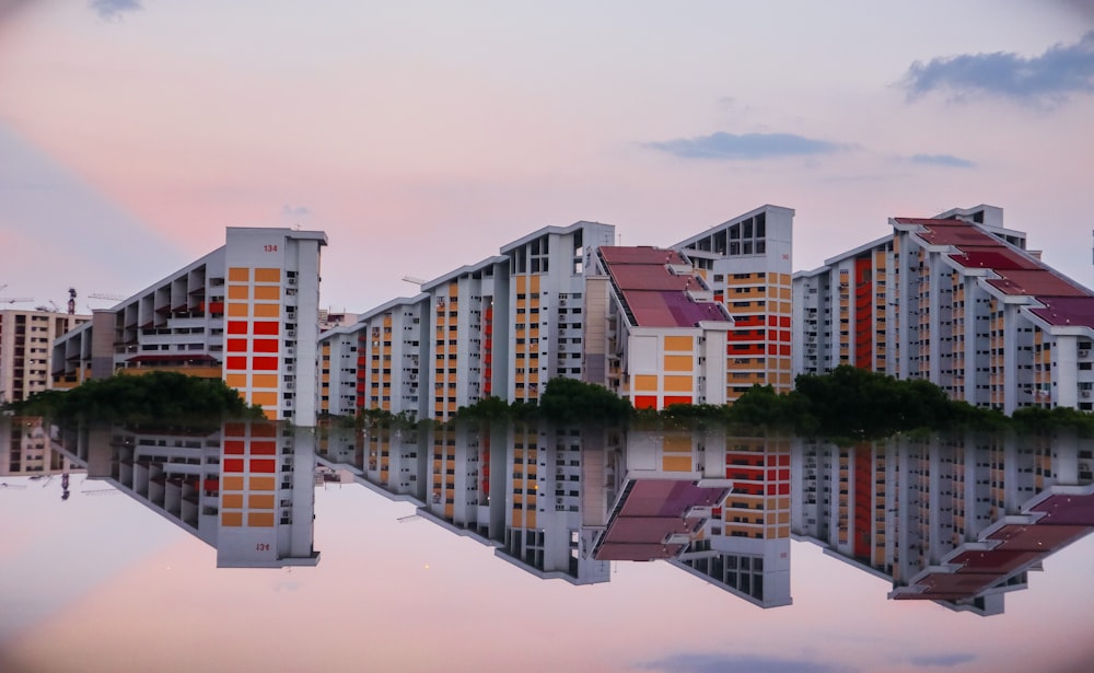 reflection photography of three buildings