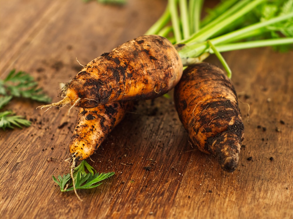 three white root crops on wooden surface