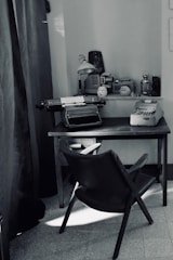 black leather padded metal framed chair near computer table