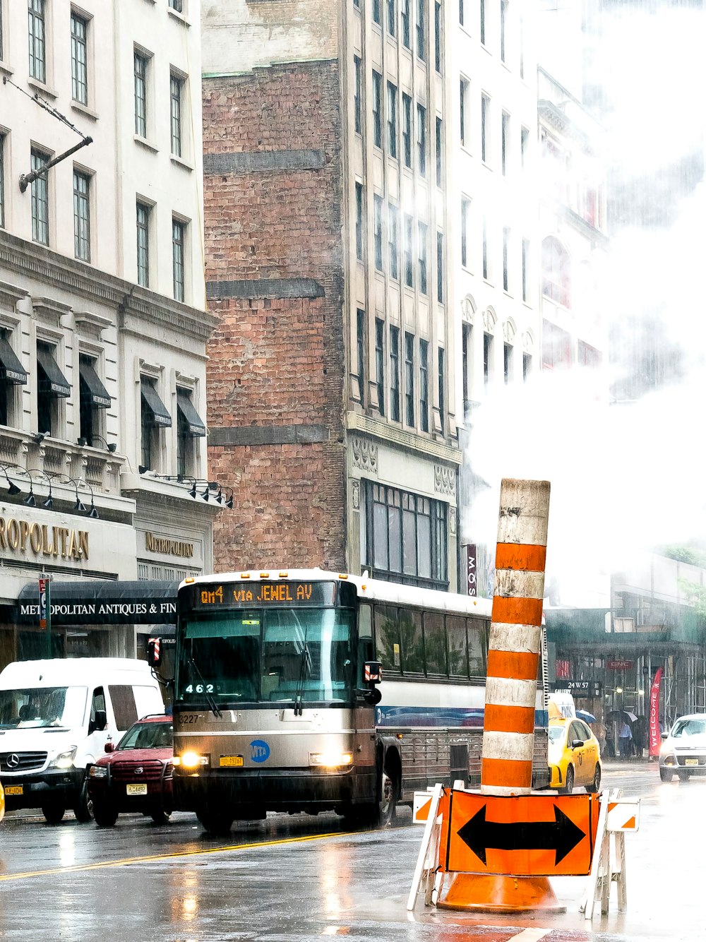 white and gray bus traveling on road during daytime