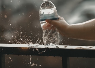 white and blue labeled disposable bottled water