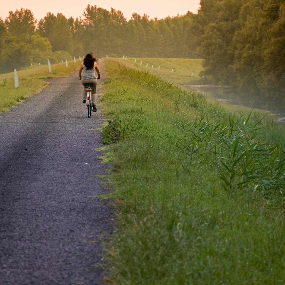 woman riding a bike in a country road