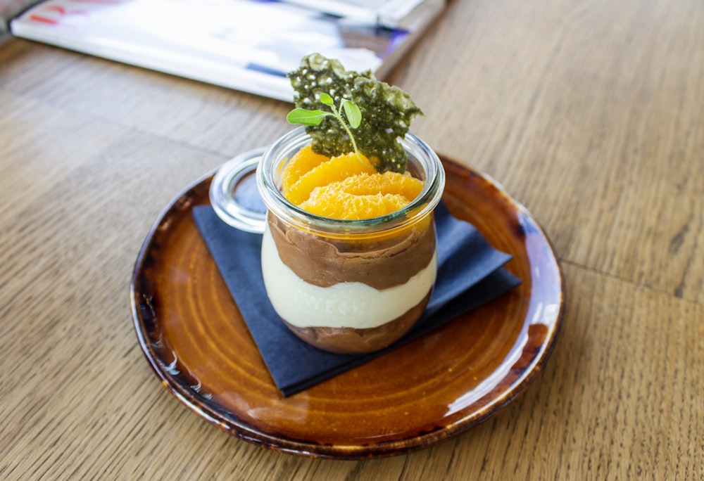 round clear glass jar with filled of dessert