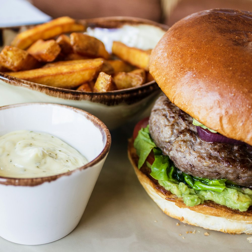 burger with green leafy vegetable and fries