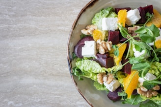 bowl of vegetable salad with walnuts