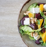 bowl of vegetable salad with walnuts