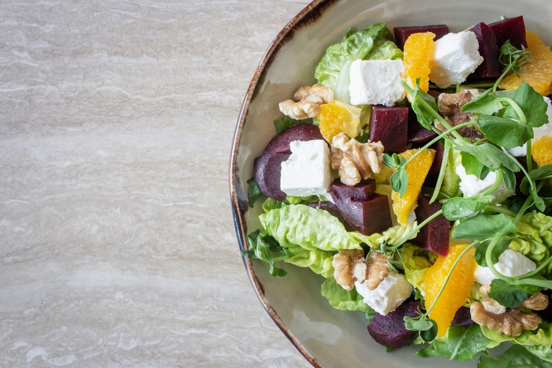 bowl of vegetable salad with walnuts,