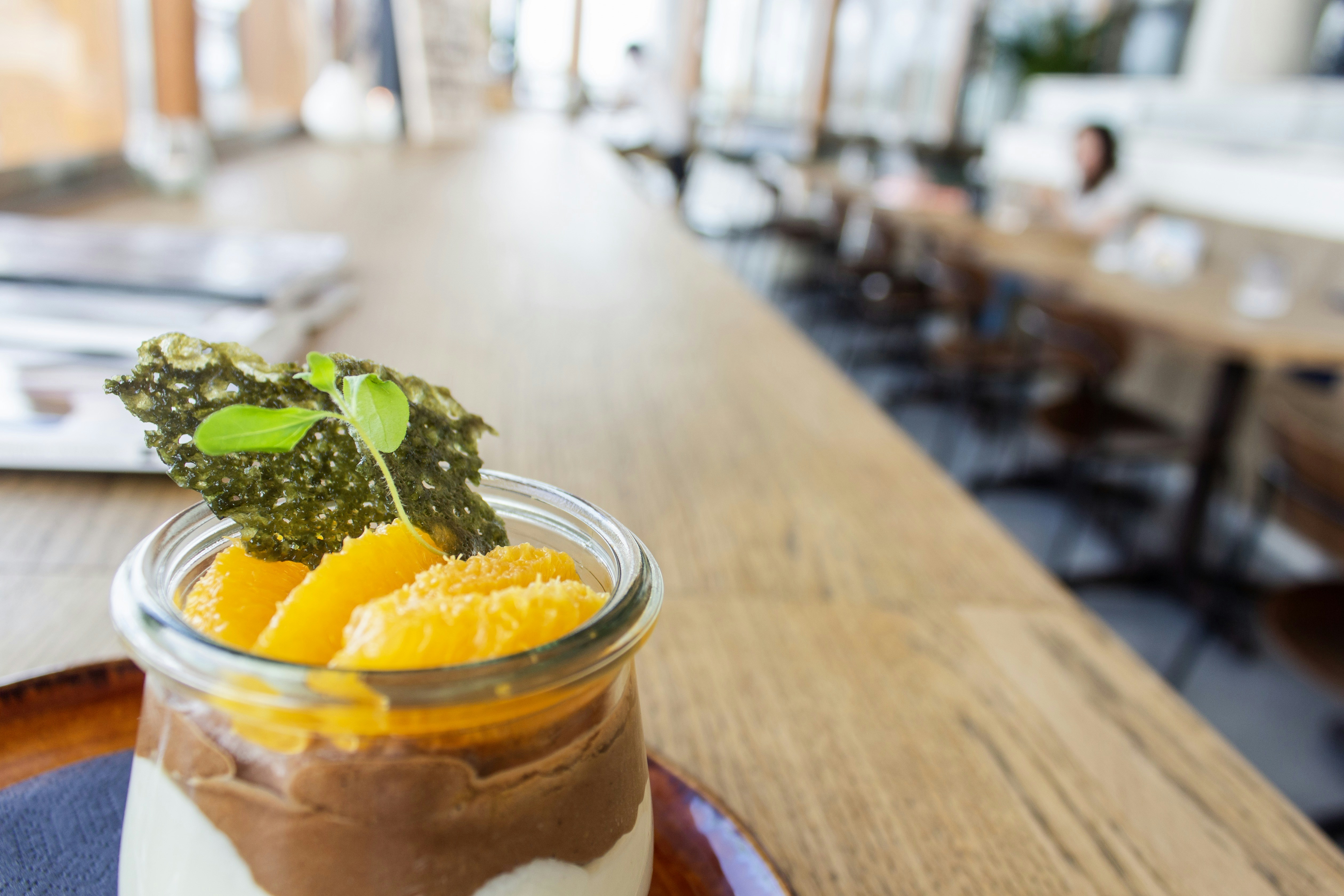 Dessert jar with orange on a long table