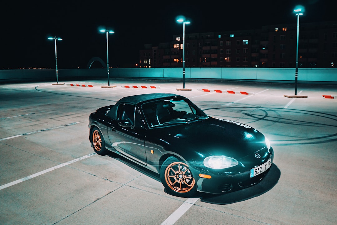 green Mazda Miata MX-5 on gray concrete floor