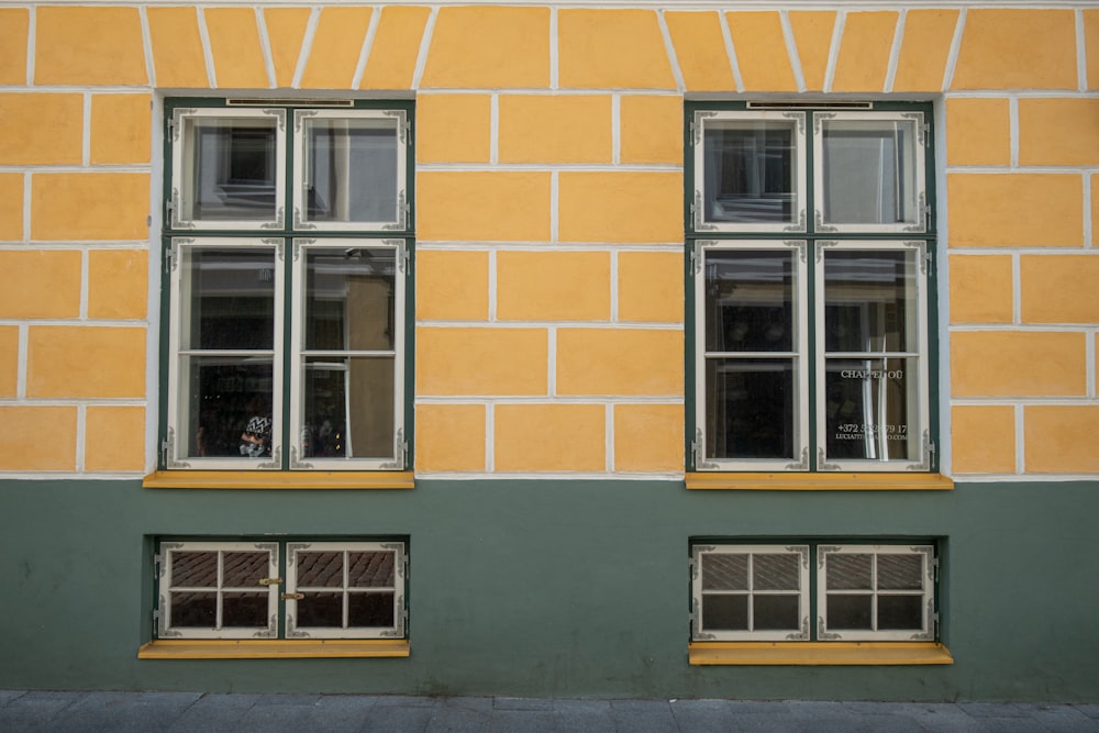 orange concrete building showing closed windows