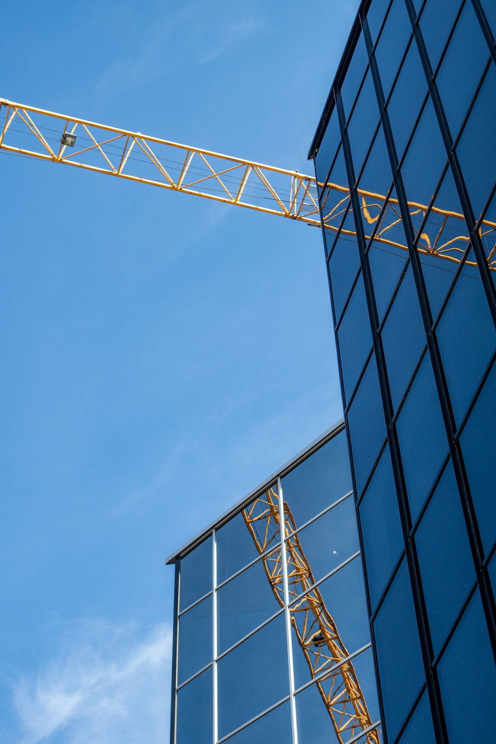 yellow metal crane and a black building