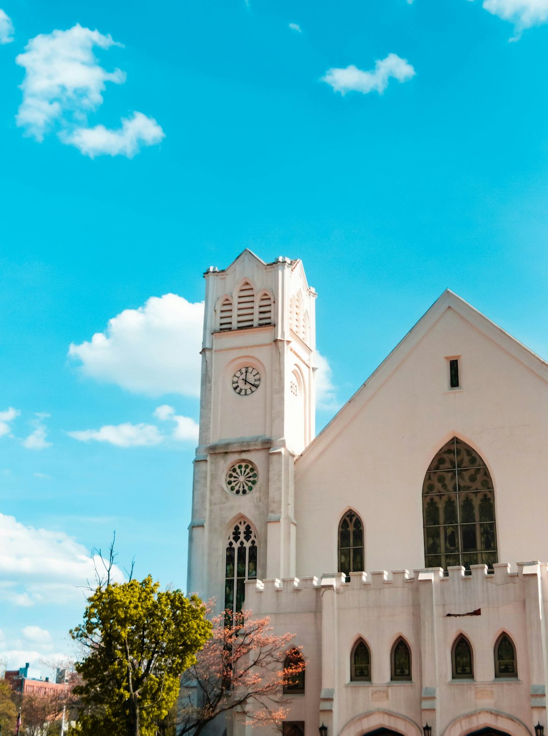 white clock tower across blue sky