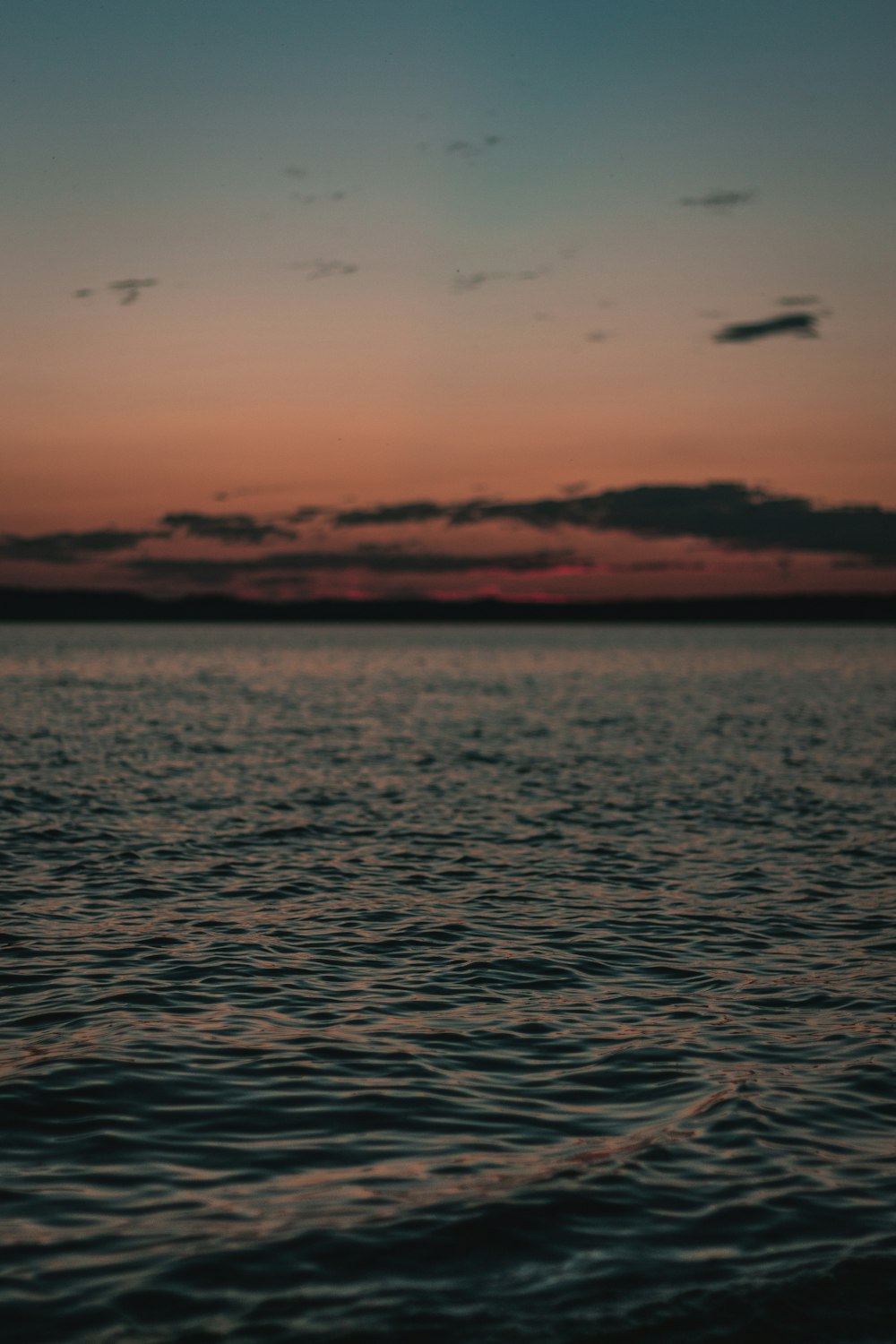 calm body of water during sunset