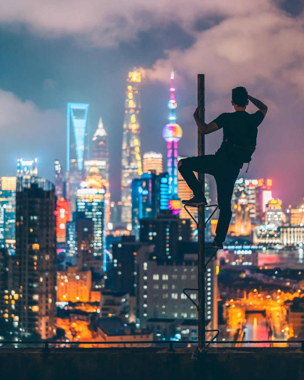 man climbing on rooftop post