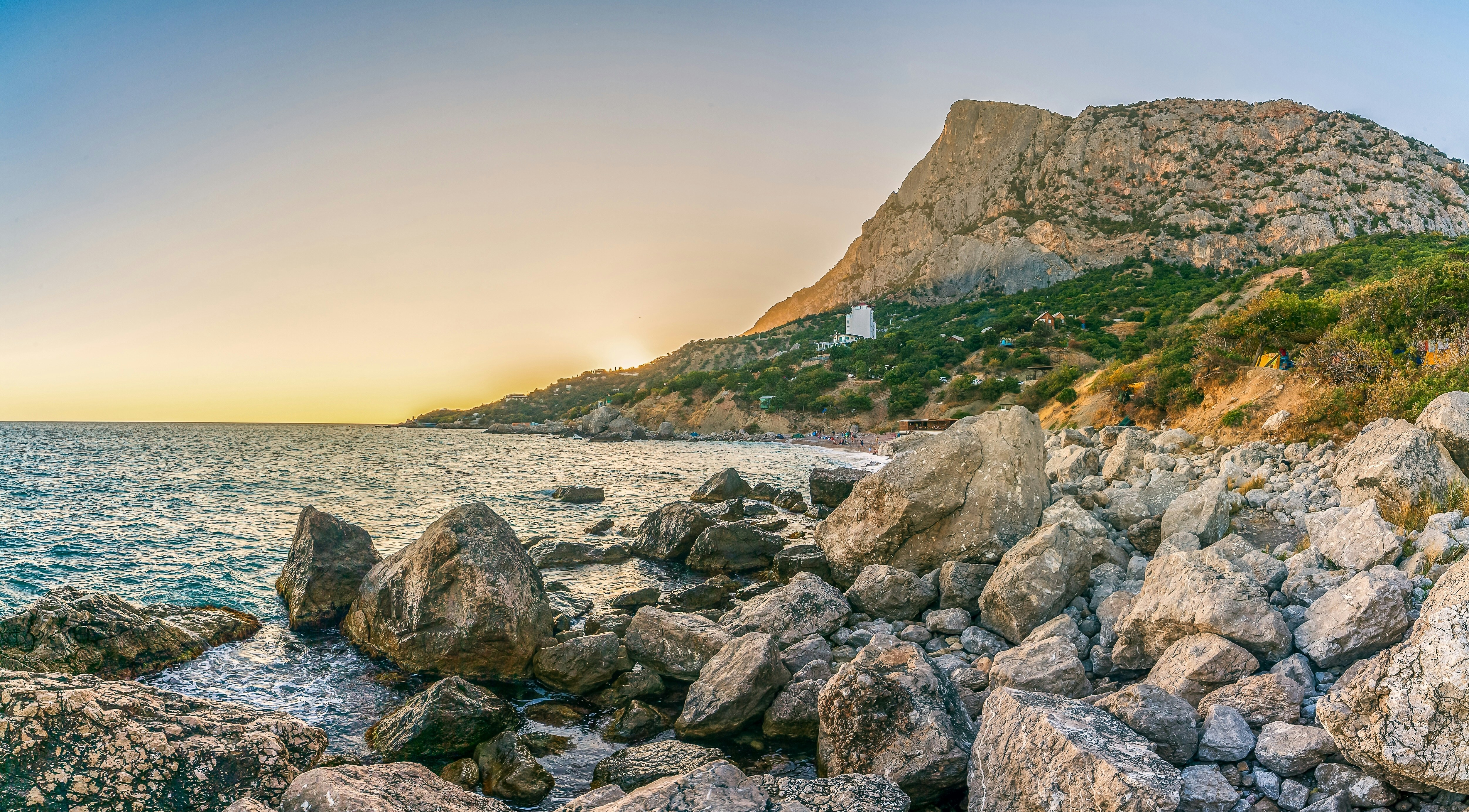 Stone formation near body of water beside a cliff during daytime photo ...