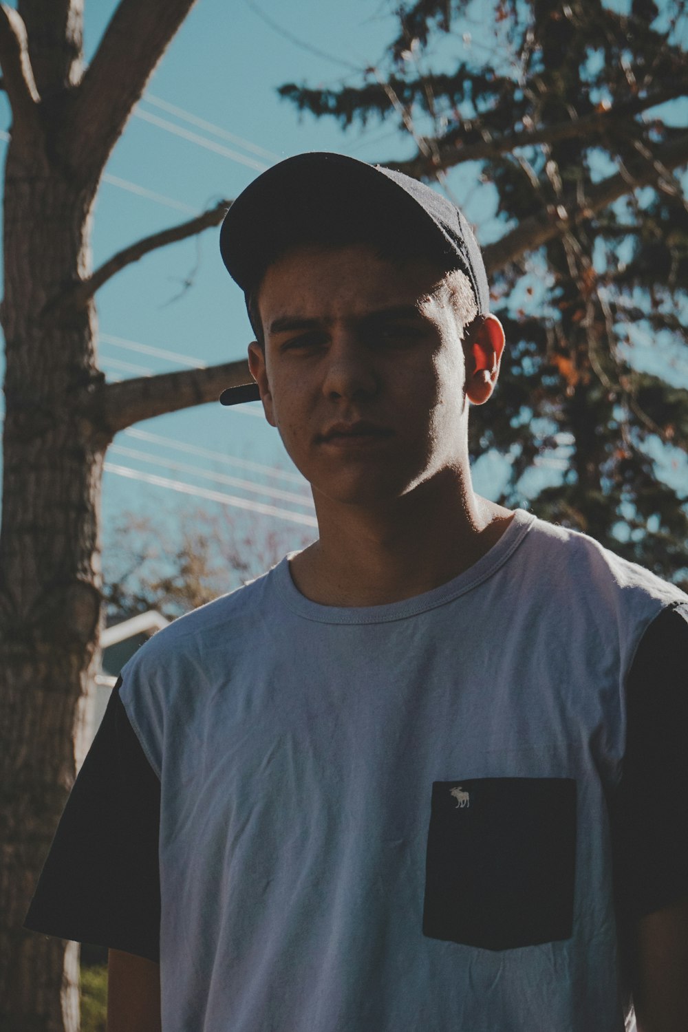 man wearing gray and black crew-neck shirt