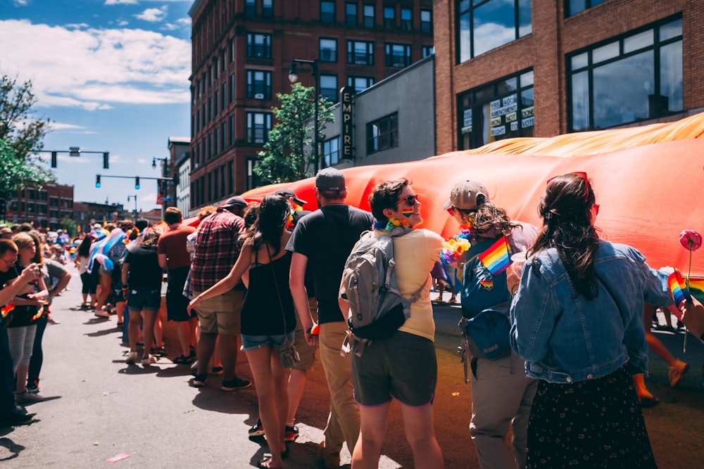 people in a road near a building during daytime