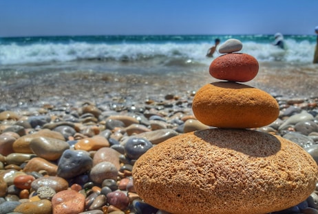 stack of orange stones on a beach