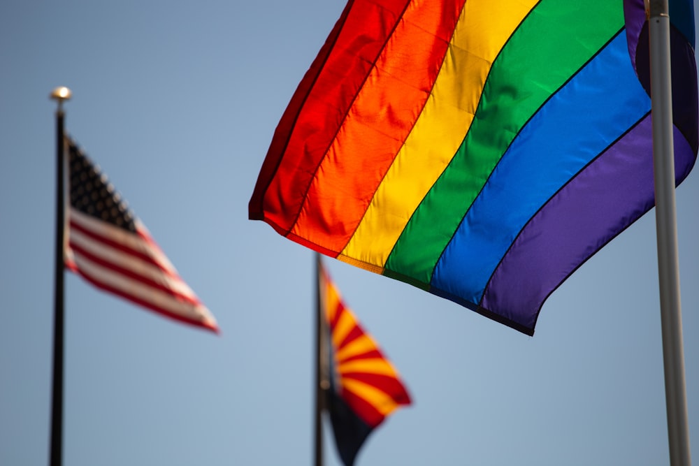 three assorted-color flags during daytime