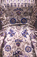 Close-up of intricate embroidery on an ivory saree with navy blue threadwork, highlighting delicate craftsmanship.