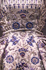 Close-up of intricate royal gold threadwork on a charcoal kurti fabric, highlighting the delicate craftsmanship.