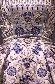 Close-up of a richly embroidered lehenga with delicate beadwork and vibrant colors.