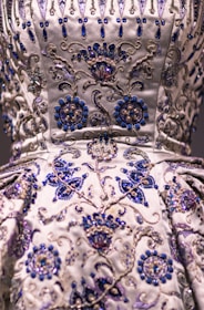 A detailed shot of rich fabric textures and delicate beadwork on a signature Bombay Sigma dress.