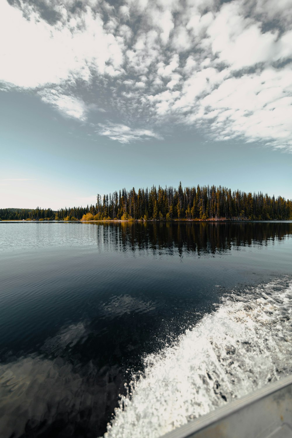 body of water under white and blue sky